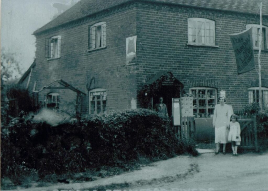 The shop was in London Road, Stanford Rivers, almost opposite the junction with Berwick Lane. The banner outside the premises says, ‘Teas, Minerals and Light Refreshments’ and is now the home of member Christine Marchant.
The shop presumably provided sustenance to passing cyclists!
The sign on the side of the shop is an advertising sign for
Black Cat cigarettes (see page 39)