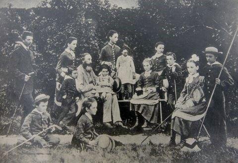 Family group showing 13 of the 14 children. Mary is sitting on the chair on the far right.